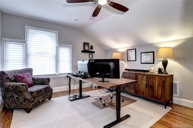 office area featuring light hardwood / wood-style flooring, ceiling fan, and vaulted ceiling