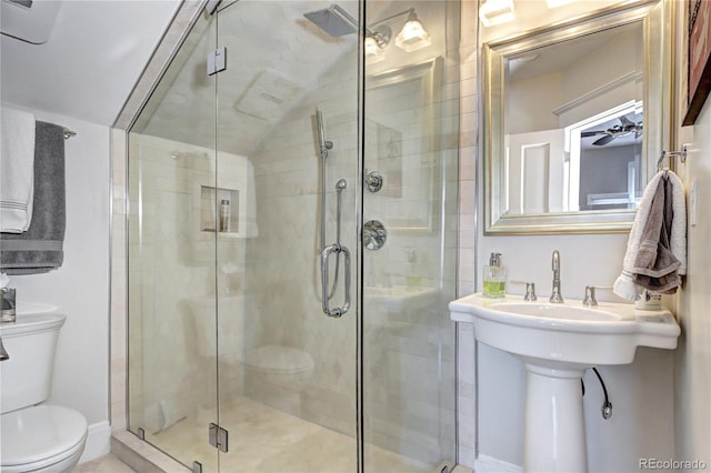 bathroom with toilet, lofted ceiling, and an enclosed shower