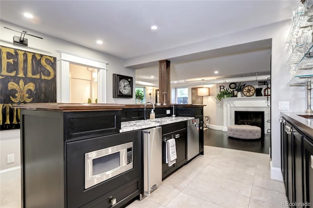 kitchen with sink, stainless steel appliances, and light tile patterned floors