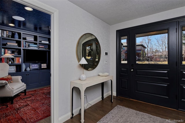 entrance foyer featuring dark hardwood / wood-style floors and a textured ceiling