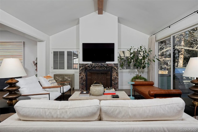 living room featuring vaulted ceiling with beams and a fireplace