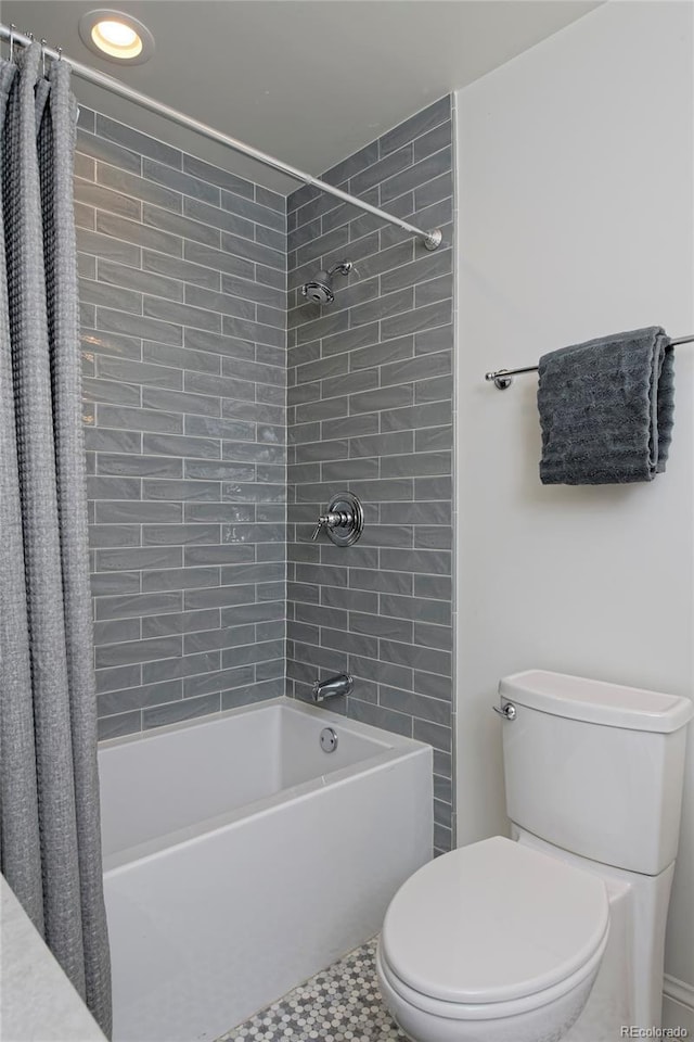 bathroom with toilet and shower / tub combo