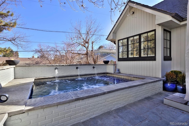 view of pool featuring a hot tub