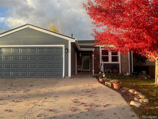 8893 W Ontario Ave, Littleton, CO 80128 - single story home with brick siding, driveway, and a garage