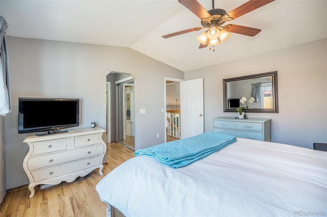 8893 W Ontario Ave, Littleton, CO 80128 - bedroom featuring baseboards, a ceiling fan, lofted ceiling, arched walkways, and light wood finished floors
