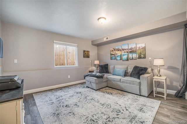 8893 W Ontario Ave, Littleton, CO 80128 - living room featuring visible vents, baseboards, and wood finished floors