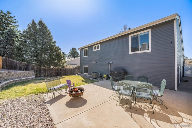 8893 W Ontario Ave, Littleton, CO 80128 - back of house with central AC, a yard, an outdoor fire pit, a fenced backyard, and a patio