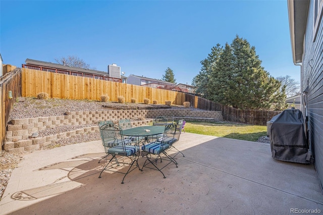 8893 W Ontario Ave, Littleton, CO 80128 - view of patio / terrace with outdoor dining space, a fenced backyard, and area for grilling