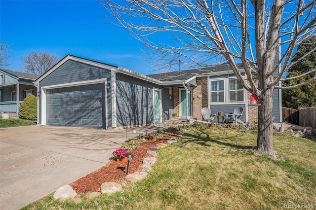 8893 W Ontario Ave, Littleton, CO 80128 - single story home featuring a front yard, a garage, fence, brick siding, and driveway