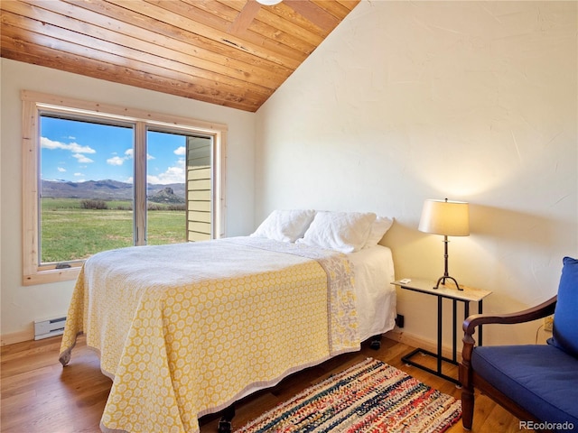 741 Big Wall Ln, La Veta, CO 81055 - bedroom featuring baseboard heating, lofted ceiling, wood finished floors, wooden ceiling, and baseboards