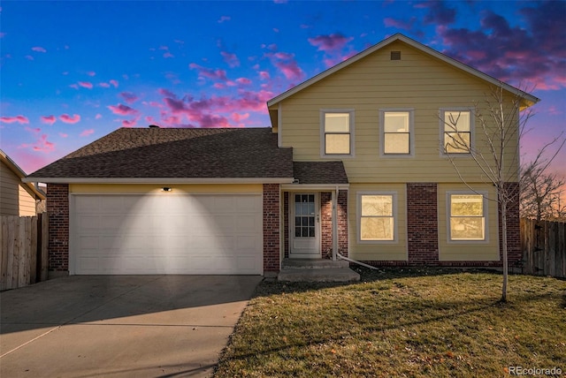 view of front property featuring a garage and a lawn