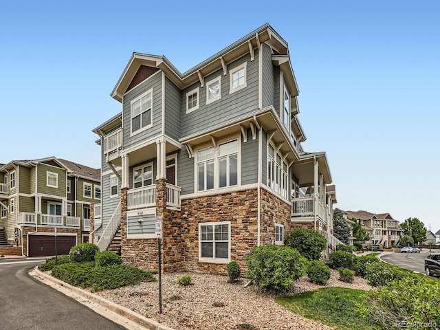 9363 Amison Cir Unit 106, Parker, CO 80134 - view of building exterior featuring stairs, an attached garage, and asphalt driveway