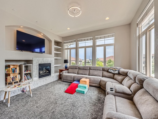 9363 Amison Cir Unit 106, Parker, CO 80134 - carpeted living room featuring built in shelves, recessed lighting, and a fireplace