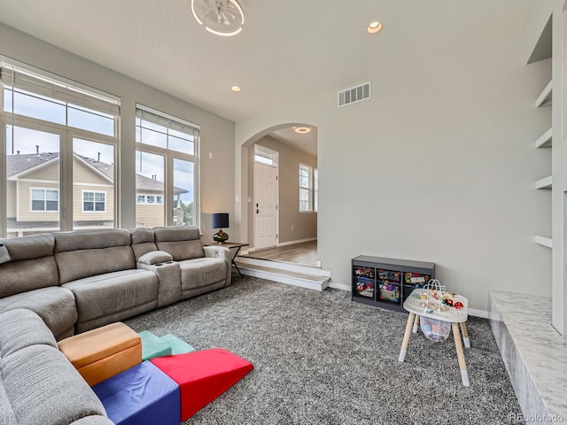 9363 Amison Cir Unit 106, Parker, CO 80134 - carpeted living room with arched walkways, baseboards, and recessed lighting