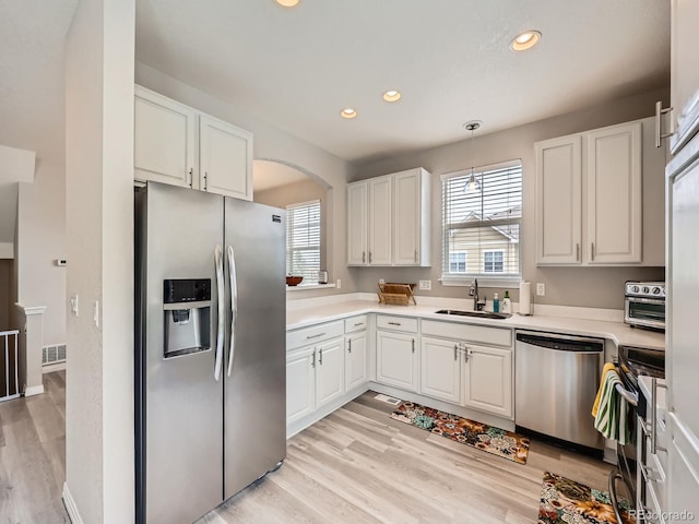9363 Amison Cir Unit 106, Parker, CO 80134 - kitchen featuring appliances with stainless steel finishes, a sink, recessed lighting, light wood finished floors, and white cabinetry