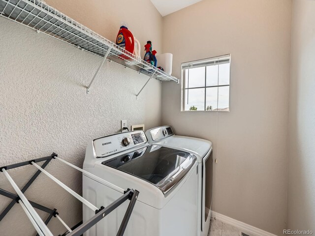 9363 Amison Cir Unit 106, Parker, CO 80134 - washroom with washing machine and clothes dryer and baseboards