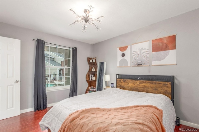 bedroom with baseboards and wood finished floors