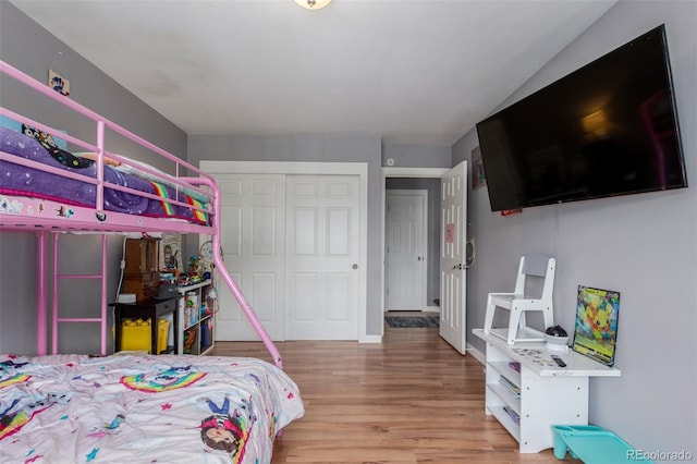 bedroom with a closet and wood finished floors