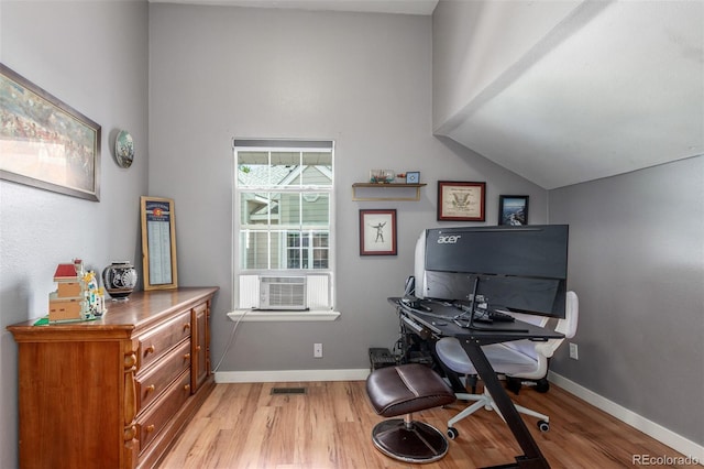 office with light wood-style floors, baseboards, cooling unit, and visible vents