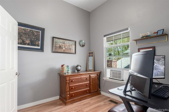 office featuring baseboards, visible vents, light wood finished floors, and cooling unit