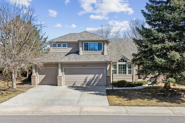 view of front of property featuring concrete driveway, brick siding, a garage, and a shingled roof