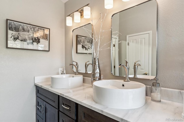 bathroom with double vanity and a sink