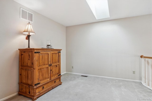 bedroom with light carpet, visible vents, a skylight, and baseboards