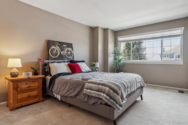 bedroom with visible vents, baseboards, and light colored carpet