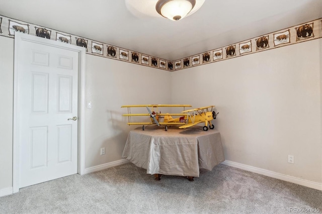 unfurnished bedroom featuring carpet and baseboards