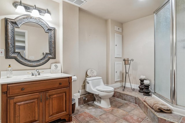 bathroom with visible vents, an enclosed shower, toilet, baseboards, and vanity