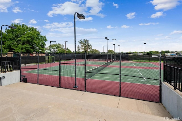 view of tennis court with fence