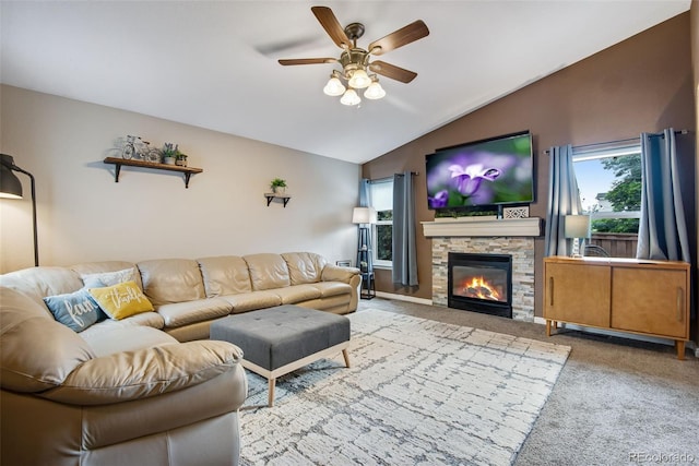1179 S Alton Ct, Denver, CO 80247 - living area with lofted ceiling, a ceiling fan, carpet flooring, and a stone fireplace