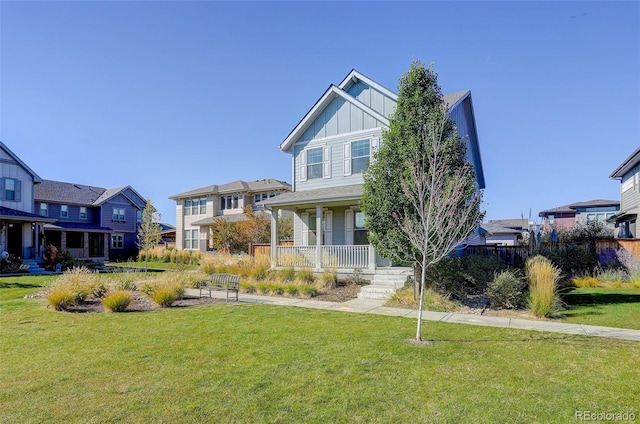 view of front of property featuring covered porch and a front yard