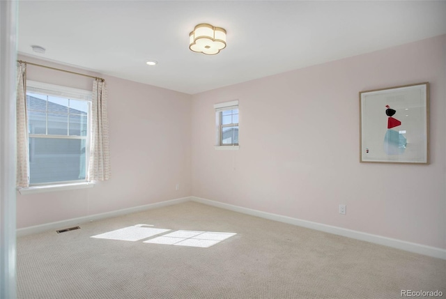 carpeted empty room featuring plenty of natural light