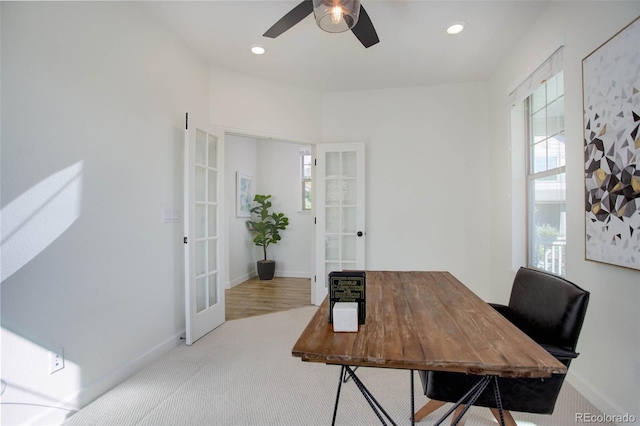 office featuring light hardwood / wood-style floors, ceiling fan, and french doors