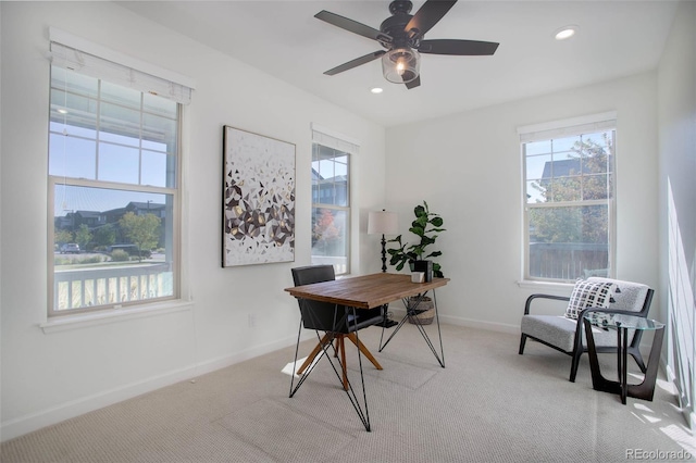 office with light carpet and ceiling fan