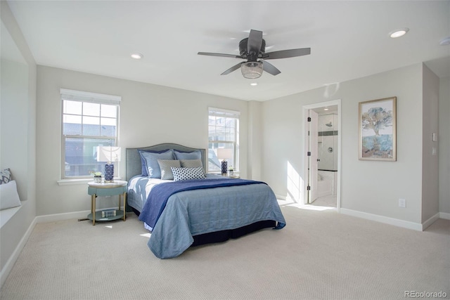 bedroom with light carpet, connected bathroom, and ceiling fan