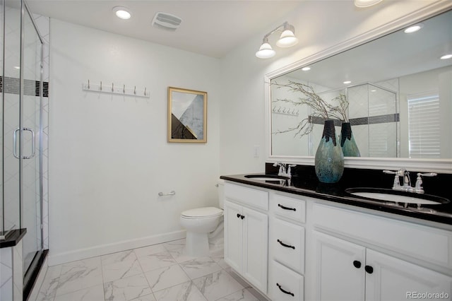 bathroom with walk in shower, vanity, and toilet