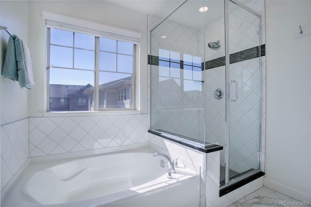 bathroom featuring separate shower and tub