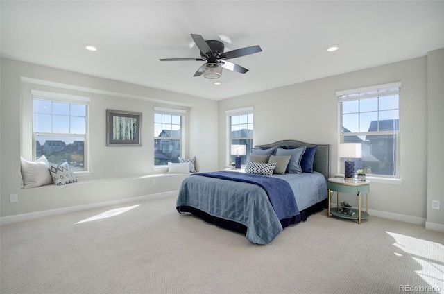 bedroom featuring multiple windows, carpet flooring, and ceiling fan