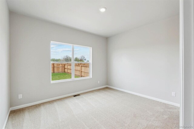 carpeted spare room with baseboards and recessed lighting