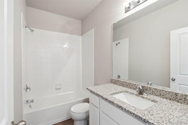full bathroom featuring vanity, bathtub / shower combination, and toilet