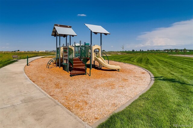 community jungle gym featuring a lawn