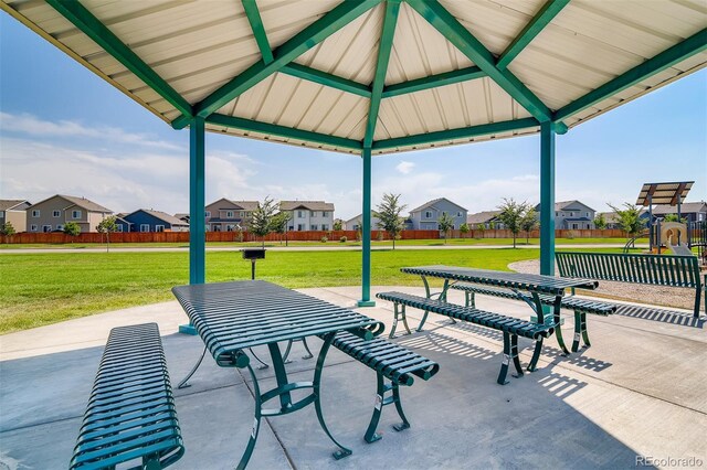 view of patio / terrace with a residential view, fence, and a gazebo