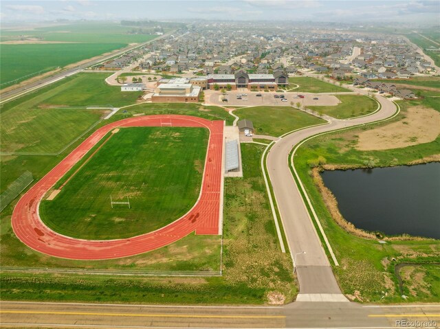 drone / aerial view featuring a water view and a residential view
