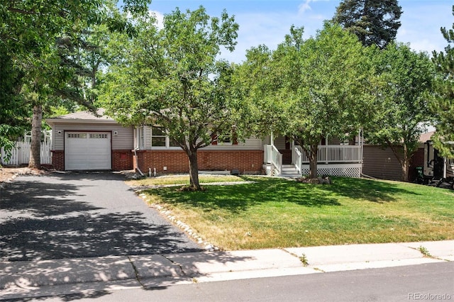6749 S Foresthill St, Littleton, CO 80120 - obstructed view of property with brick siding, an attached garage, asphalt driveway, a front lawn, and covered porch