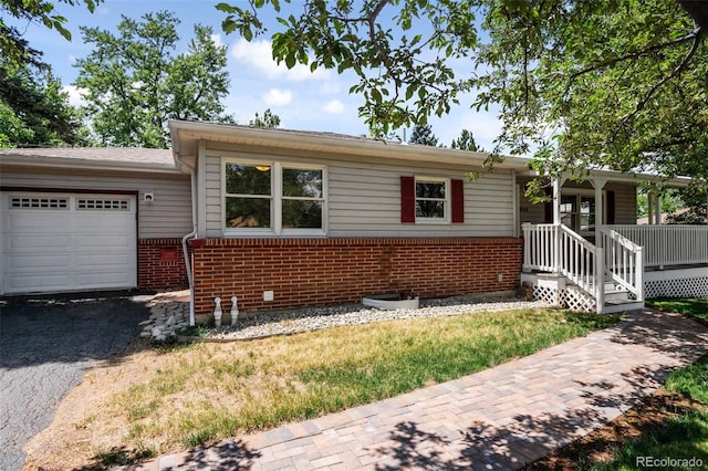 6749 S Foresthill St, Littleton, CO 80120 - single story home featuring brick siding, a garage, and asphalt driveway