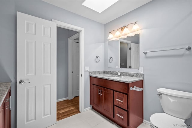 6749 S Foresthill St, Littleton, CO 80120 - bathroom featuring vanity, a skylight, and tile patterned flooring