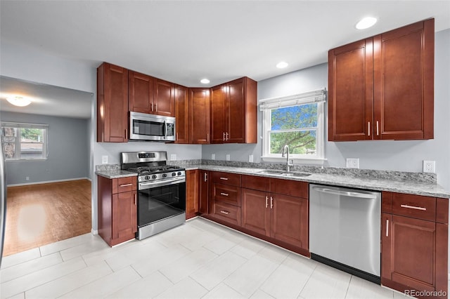 6749 S Foresthill St, Littleton, CO 80120 - kitchen with appliances with stainless steel finishes, light stone countertops, and recessed lighting