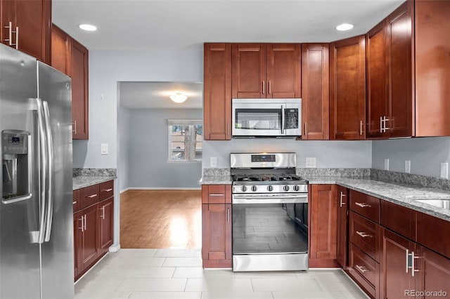 6749 S Foresthill St, Littleton, CO 80120 - kitchen featuring stainless steel appliances, light stone countertops, and recessed lighting